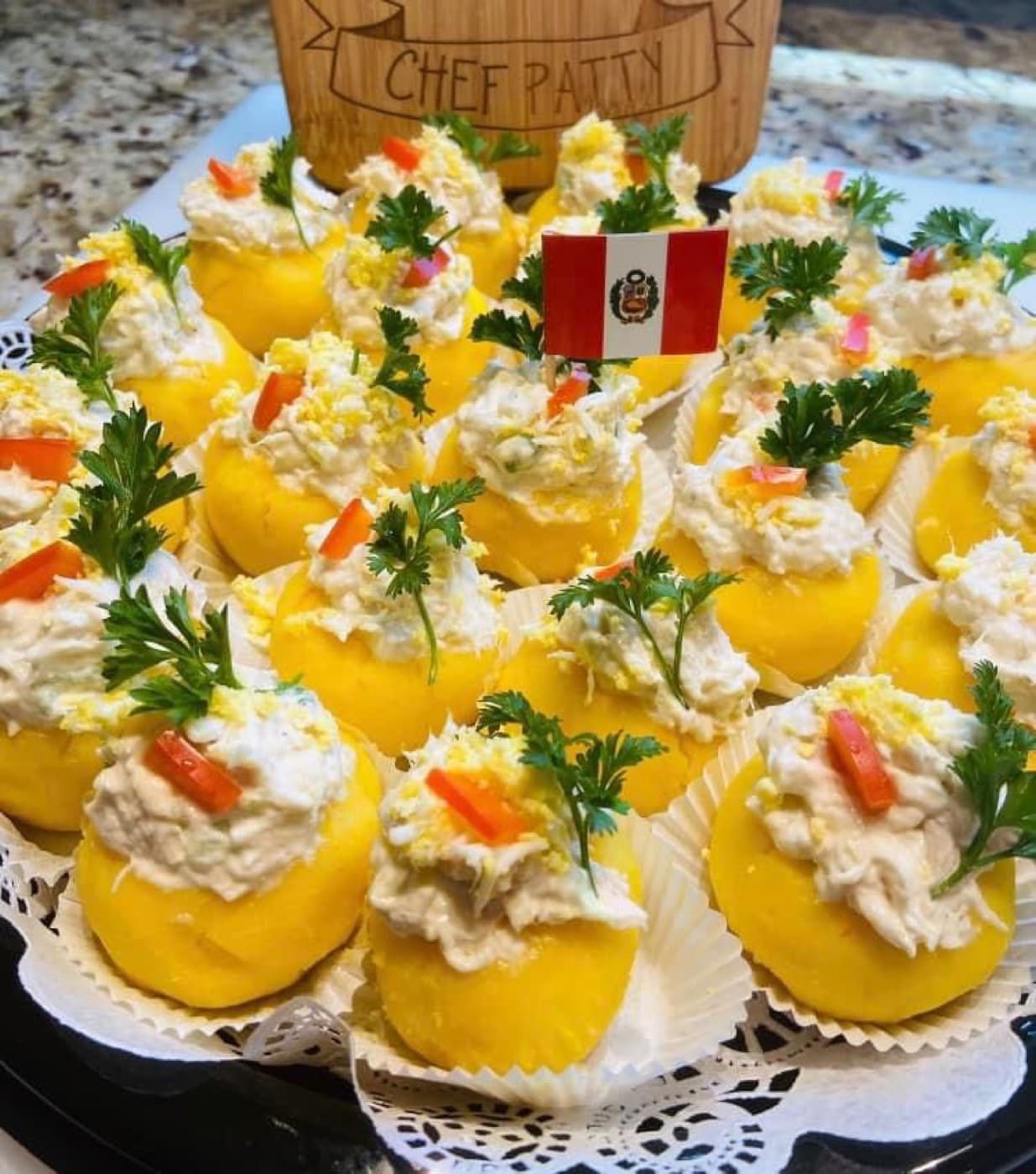 Peruvian causa limeña appetizers garnished and topped with a small Peru flag