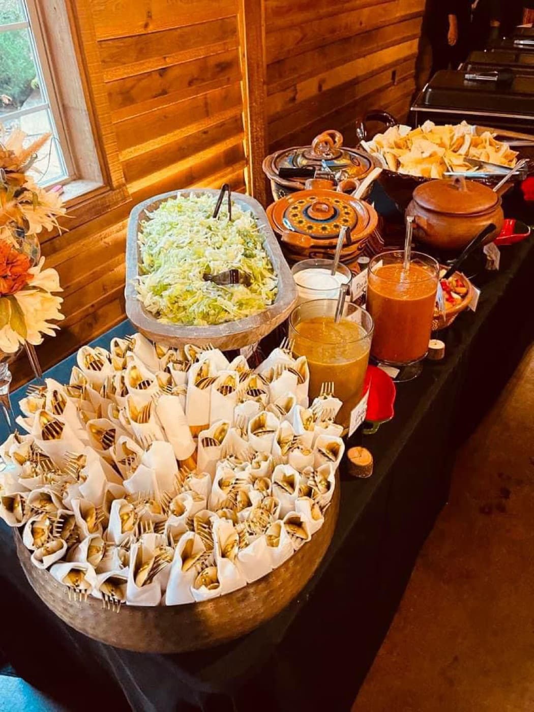 Latin-style buffet with empanadas, salads, sauces, and a clay serving pot